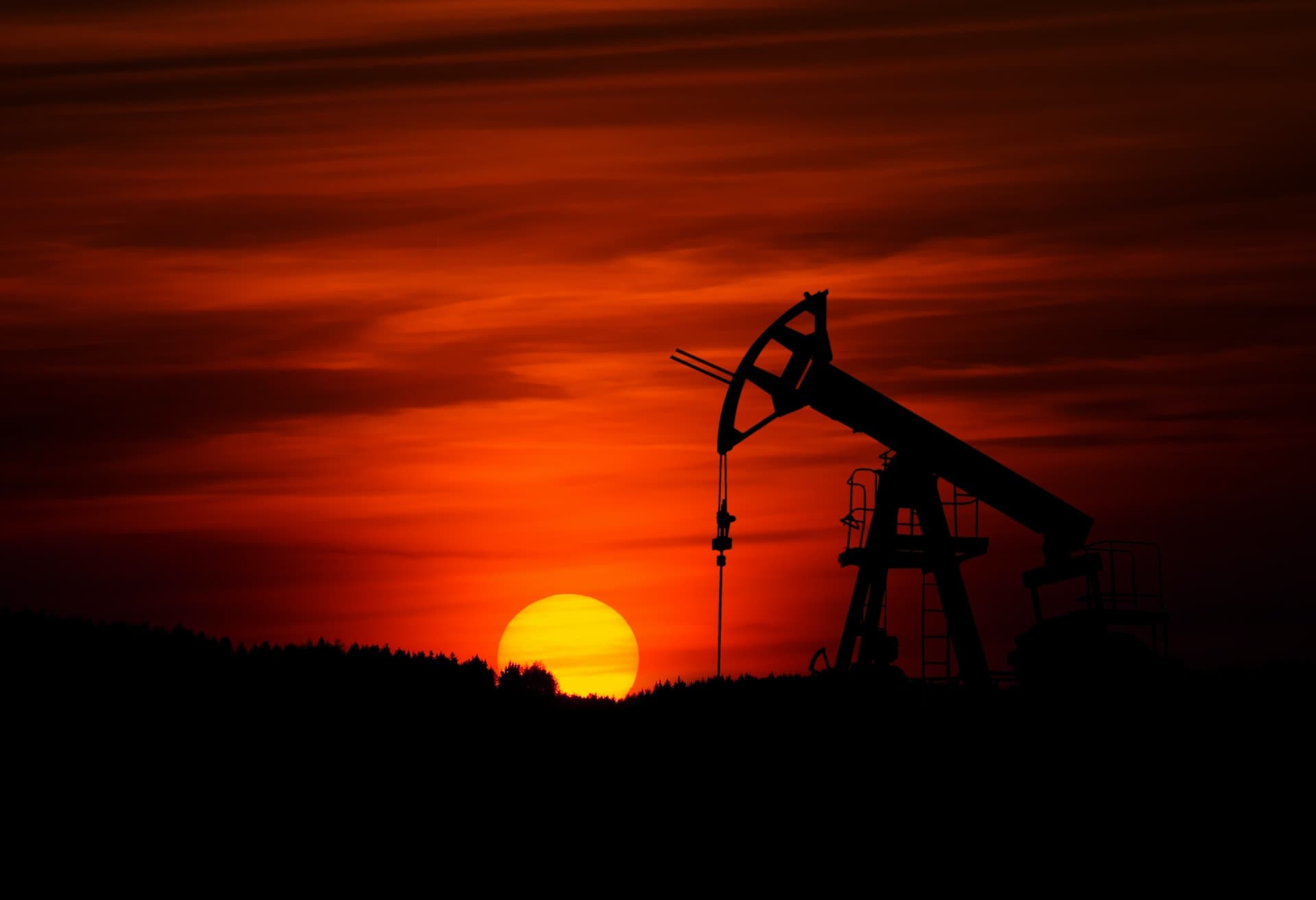 Pump-jack mining crude oil with the sunset